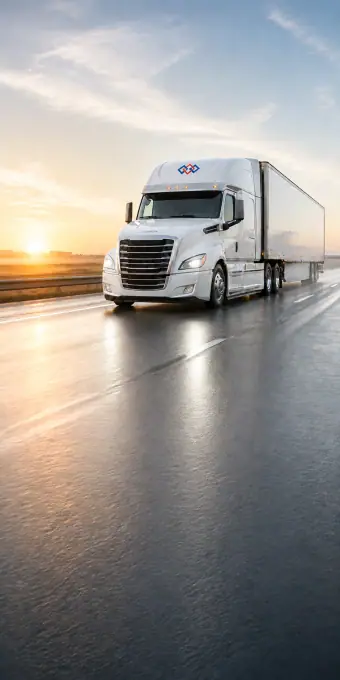 A branded modern tractor-trailer running a clean dawn highway with open sky for homepage copy — portrait framing for phones